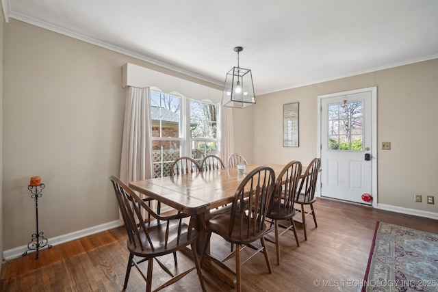 dining space with dark wood finished floors, baseboards, a wealth of natural light, and ornamental molding