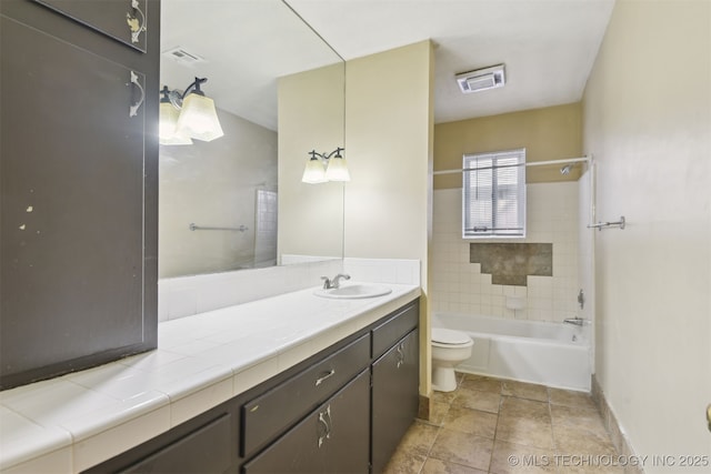 full bathroom with visible vents, toilet, vanity, and shower / bathing tub combination