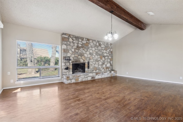 unfurnished living room with a notable chandelier, wood finished floors, and a textured ceiling