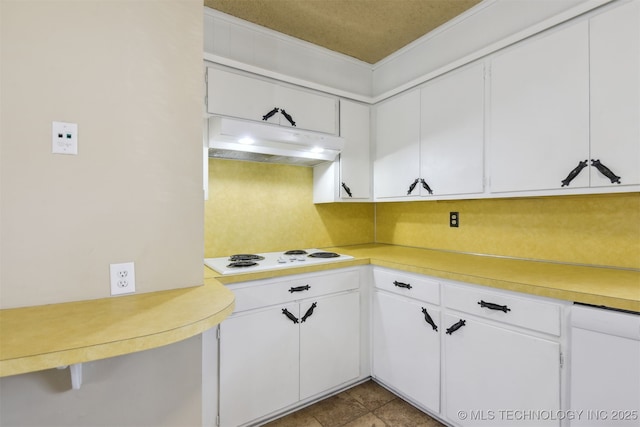 kitchen featuring light countertops, white cabinets, under cabinet range hood, and white electric cooktop