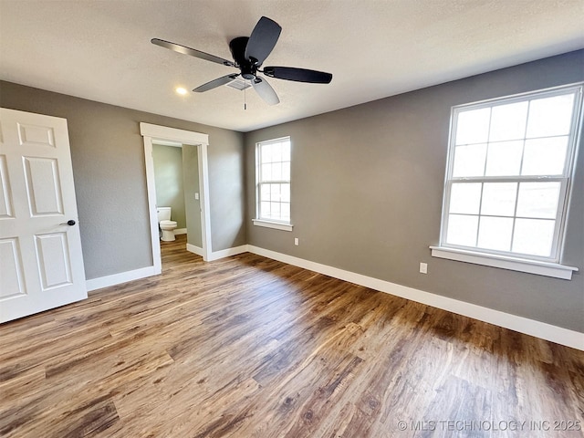 17022 S 579th Rd, Tahlequah, OK 74464 - unfurnished bedroom featuring wood finished floors, connected bathroom, ceiling fan, and recessed lighting