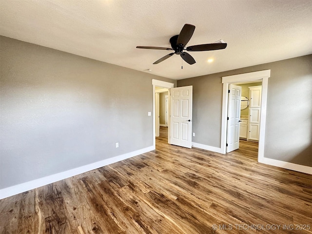 17022 S 579th Rd, Tahlequah, OK 74464 - unfurnished bedroom with wood finished floors, ceiling fan, and a textured ceiling