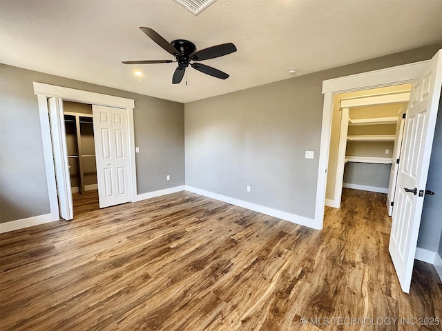17022 S 579th Rd, Tahlequah, OK 74464 - unfurnished bedroom featuring wood finished floors, a closet, and a ceiling fan