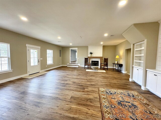 17022 S 579th Rd, Tahlequah, OK 74464 - unfurnished living room with recessed lighting, dark wood-style flooring, and a large fireplace