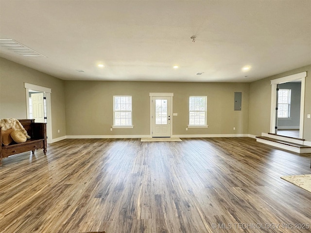 17022 S 579th Rd, Tahlequah, OK 74464 - unfurnished living room with healthy amount of natural light, wood finished floors, electric panel, and recessed lighting