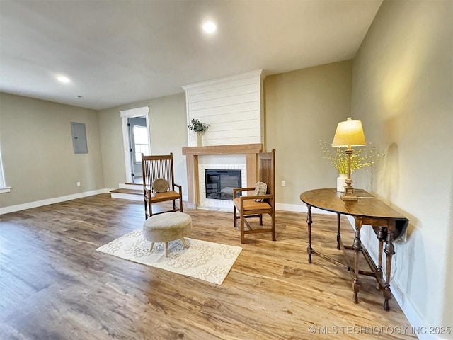 17022 S 579th Rd, Tahlequah, OK 74464 - sitting room featuring electric panel, wood finished floors, a large fireplace, and recessed lighting