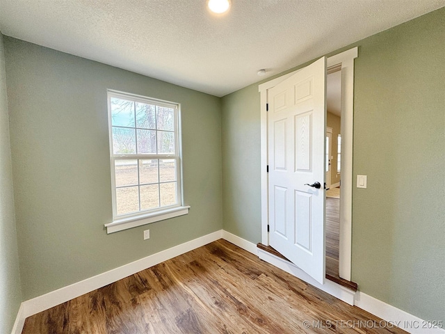 17022 S 579th Rd, Tahlequah, OK 74464 - spare room with wood finished floors and a textured ceiling