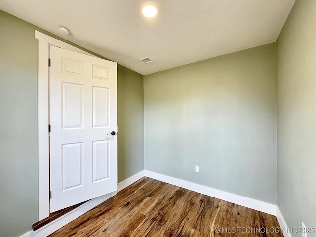 17022 S 579th Rd, Tahlequah, OK 74464 - unfurnished bedroom with baseboards and dark wood-style flooring