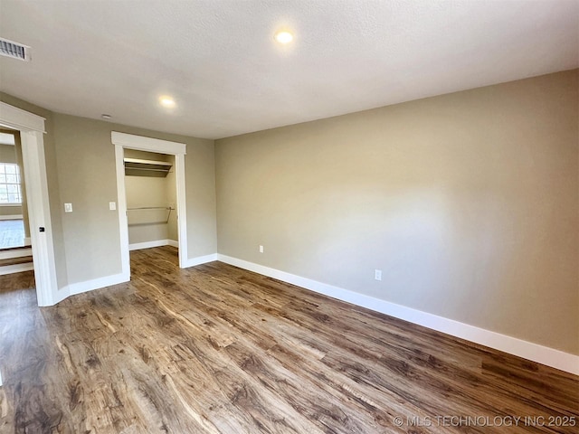 17022 S 579th Rd, Tahlequah, OK 74464 - unfurnished bedroom with wood finished floors, recessed lighting, a spacious closet, and a closet
