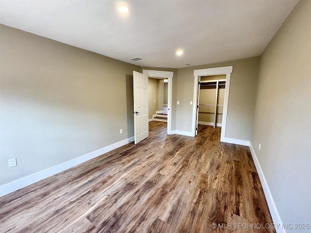 17022 S 579th Rd, Tahlequah, OK 74464 - unfurnished bedroom with wood finished floors, a spacious closet, a closet, and recessed lighting