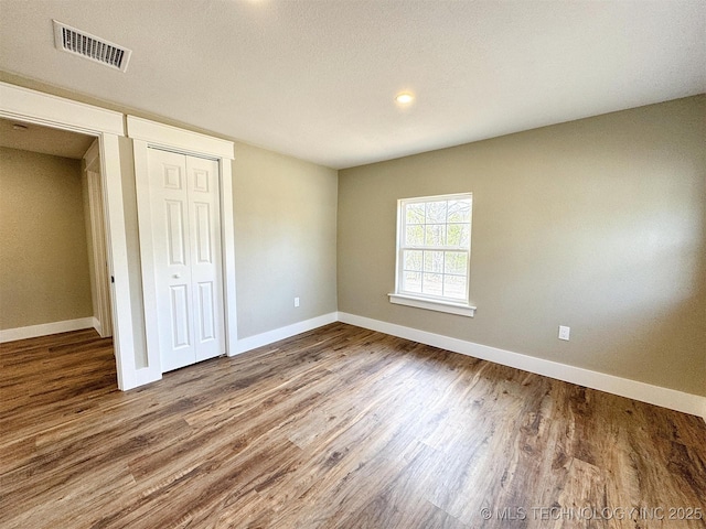17022 S 579th Rd, Tahlequah, OK 74464 - unfurnished bedroom featuring wood finished floors and a closet