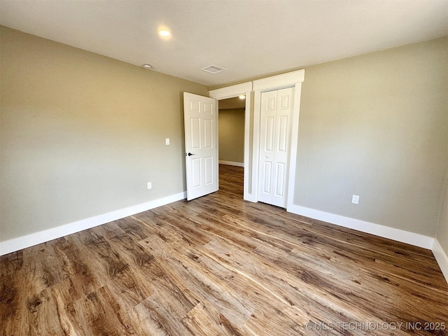 17022 S 579th Rd, Tahlequah, OK 74464 - unfurnished bedroom with wood finished floors and a closet