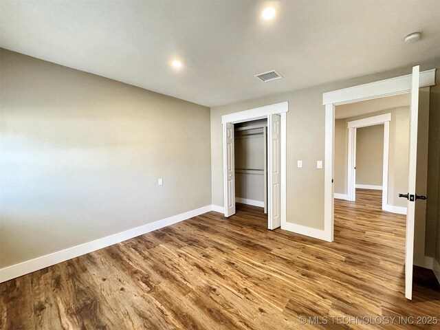 17022 S 579th Rd, Tahlequah, OK 74464 - unfurnished bedroom featuring wood finished floors, a closet, and recessed lighting