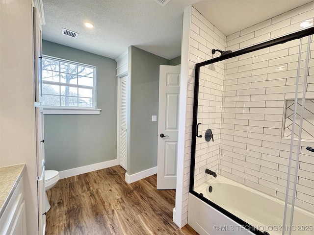 17022 S 579th Rd, Tahlequah, OK 74464 - bathroom featuring wood finished floors, shower / bathtub combination, vanity, and a textured ceiling
