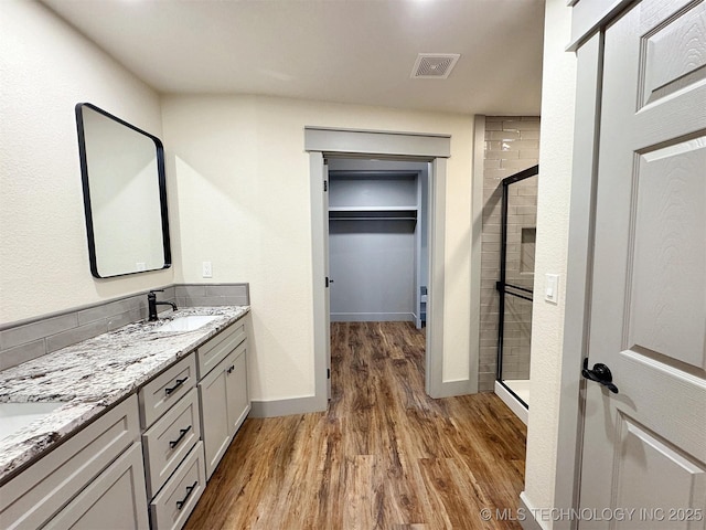 17022 S 579th Rd, Tahlequah, OK 74464 - full bath with a stall shower, wood finished floors, double vanity, and a spacious closet