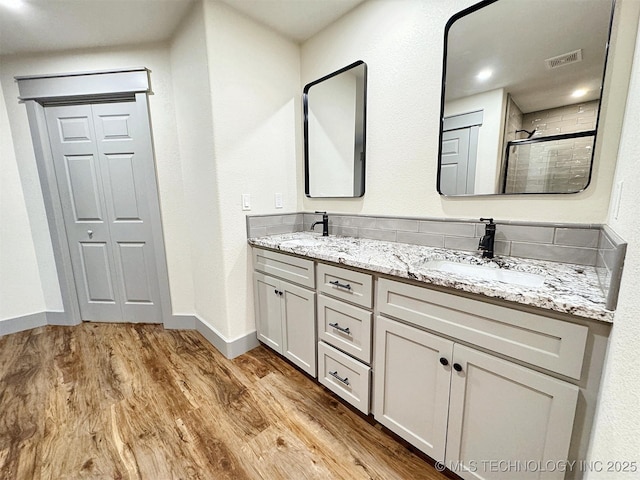 17022 S 579th Rd, Tahlequah, OK 74464 - bathroom featuring wood finished floors, double vanity, and a tile shower