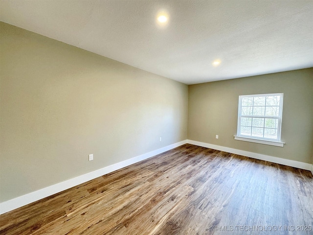 17022 S 579th Rd, Tahlequah, OK 74464 - empty room with dark wood-type flooring, recessed lighting, and a textured ceiling