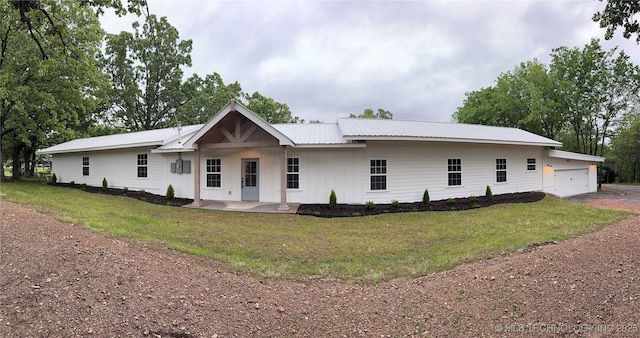 17022 S 579th Rd, Tahlequah, OK 74464 - modern farmhouse featuring a front yard, a garage, a metal roof, and board and batten siding