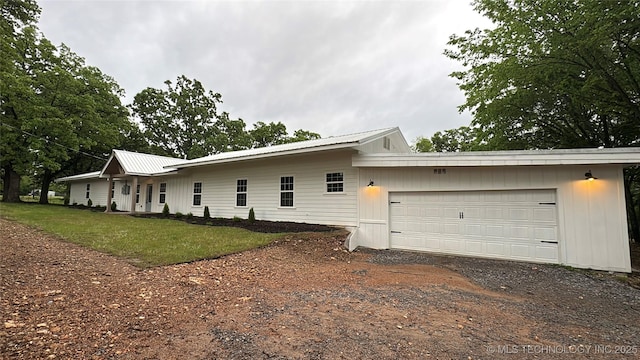 17022 S 579th Rd, Tahlequah, OK 74464 - view of side of property with dirt driveway, a garage, a metal roof, and a yard
