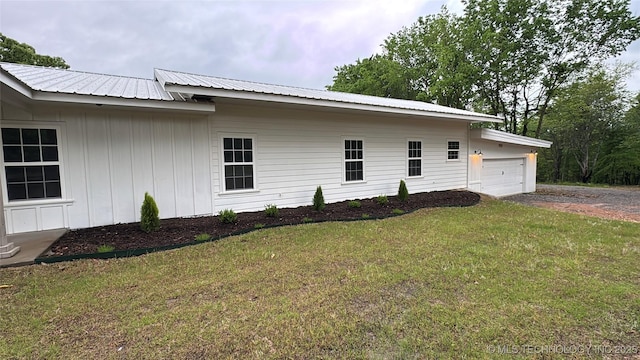 17022 S 579th Rd, Tahlequah, OK 74464 - view of side of property featuring a yard, driveway, an attached garage, a metal roof, and board and batten siding