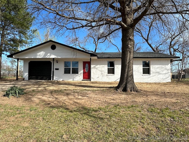 single story home featuring brick siding and a garage