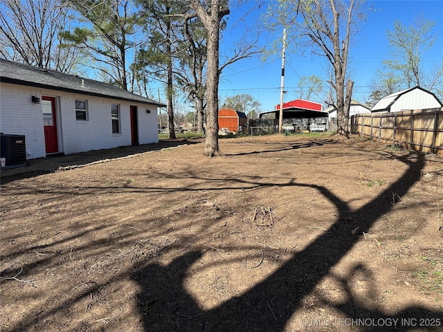 view of yard featuring cooling unit and fence
