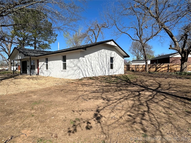 view of side of property featuring fence