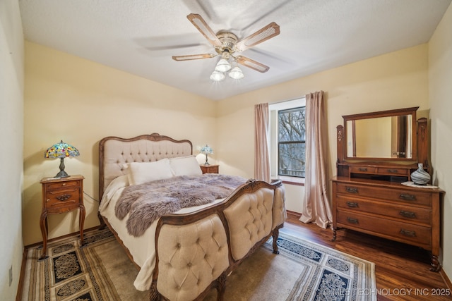 bedroom with baseboards, dark wood-style floors, and ceiling fan