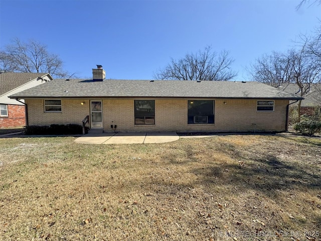 4760 S Irvington Ave, Tulsa, OK 74135 - rear view of house with a patio, roof with shingles, a chimney, a lawn, and brick siding
