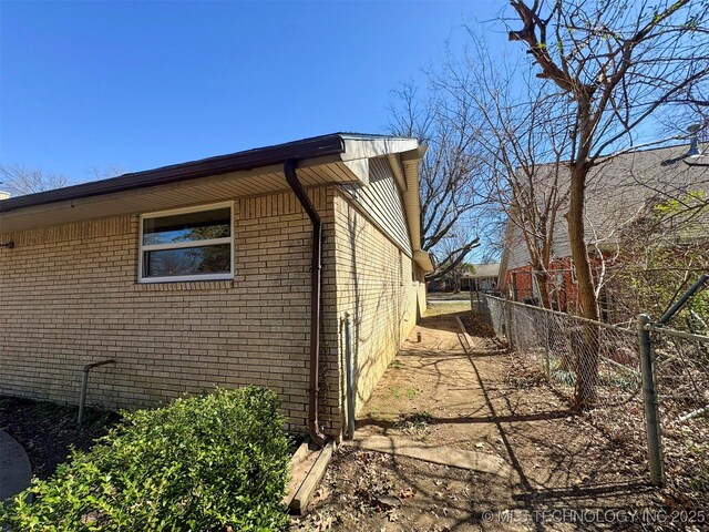 4760 S Irvington Ave, Tulsa, OK 74135 - view of side of home featuring brick siding and fence