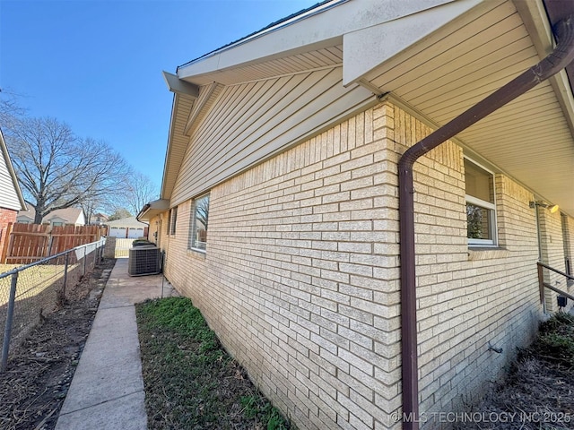 4760 S Irvington Ave, Tulsa, OK 74135 - view of home's exterior with cooling unit, brick siding, and fence
