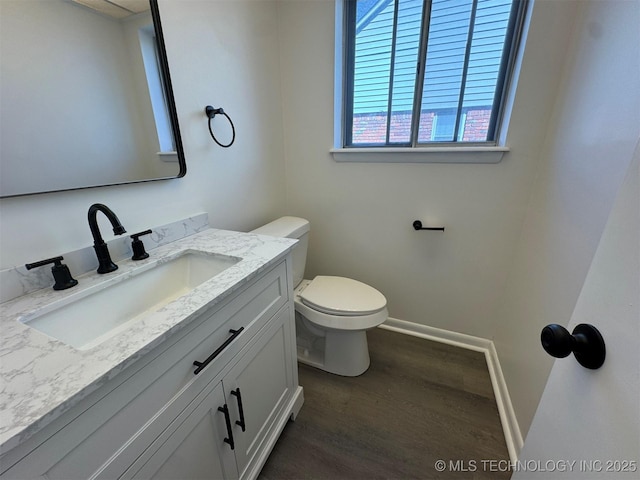 4760 S Irvington Ave, Tulsa, OK 74135 - bathroom featuring vanity, toilet, wood finished floors, and baseboards