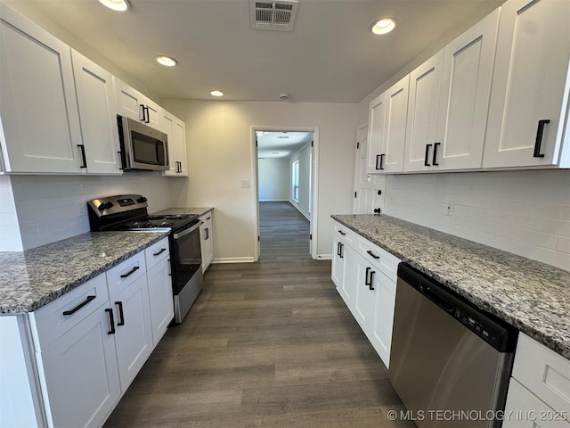 4760 S Irvington Ave, Tulsa, OK 74135 - kitchen with dark wood finished floors, white cabinets, visible vents, and stainless steel appliances