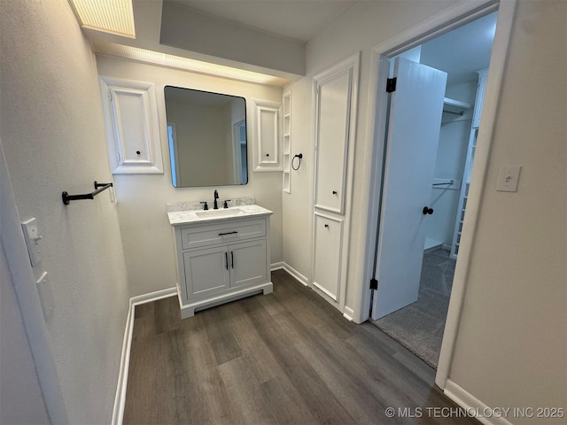 4760 S Irvington Ave, Tulsa, OK 74135 - bathroom with baseboards, wood finished floors, and vanity