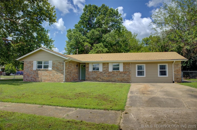 46 S 188th E Ave, Tulsa, OK 74108 - single story home with a front yard, concrete driveway, fence, and brick siding