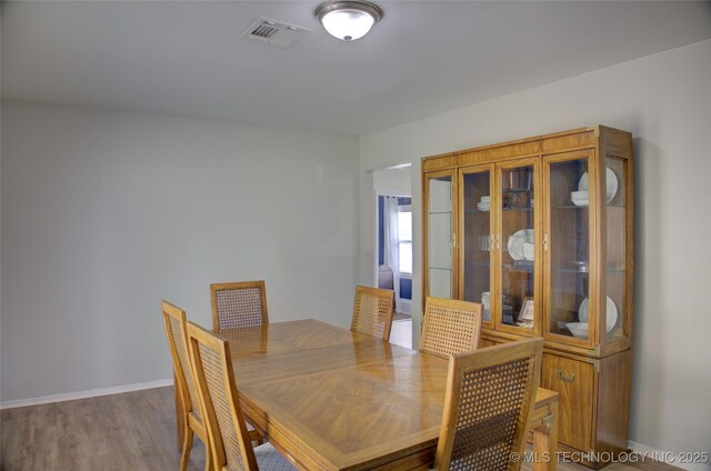 46 S 188th E Ave, Tulsa, OK 74108 - dining room featuring visible vents, baseboards, and wood finished floors