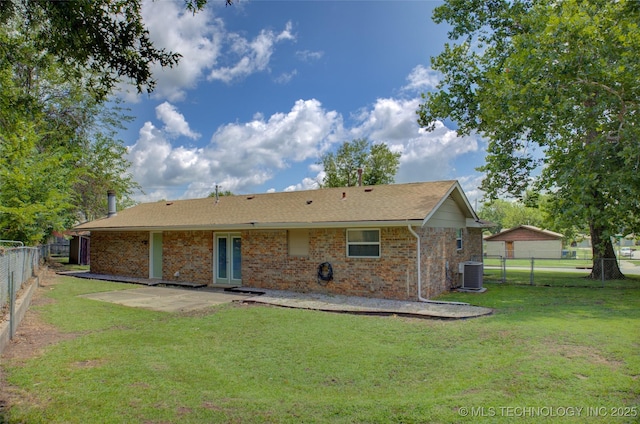 46 S 188th E Ave, Tulsa, OK 74108 - rear view of property featuring a patio, central AC unit, a fenced backyard, a lawn, and brick siding