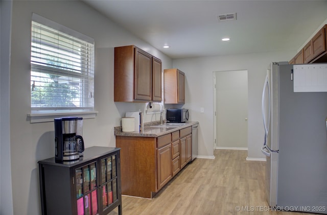 46 S 188th E Ave, Tulsa, OK 74108 - kitchen with visible vents, brown cabinets, recessed lighting, appliances with stainless steel finishes, and light wood-type flooring