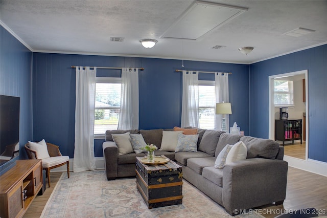 46 S 188th E Ave, Tulsa, OK 74108 - living area featuring attic access, light wood-style flooring, visible vents, and ornamental molding