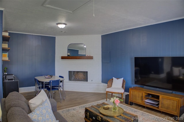 46 S 188th E Ave, Tulsa, OK 74108 - living room with a brick fireplace, crown molding, and wood finished floors