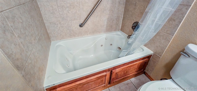 bathroom featuring tile patterned floors, toilet, and a combined bath / shower with jetted tub