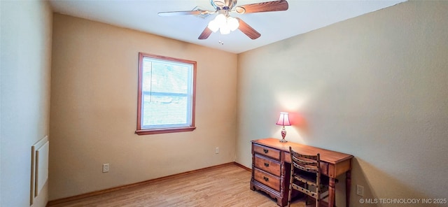 office featuring light wood-style floors, baseboards, and ceiling fan