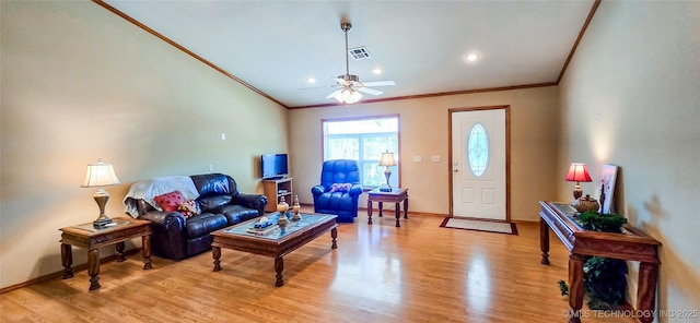 living room featuring visible vents, crown molding, baseboards, ceiling fan, and light wood-type flooring