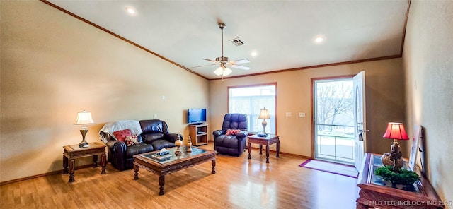 living area with a ceiling fan, baseboards, visible vents, light wood-style flooring, and ornamental molding
