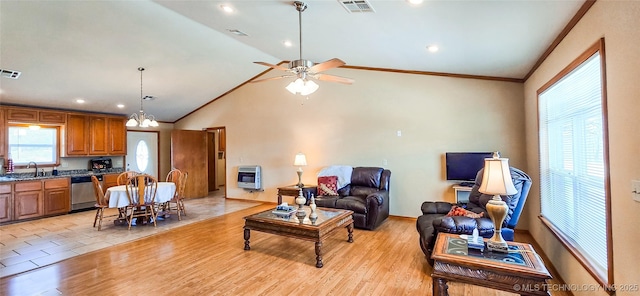 living area featuring heating unit, visible vents, light wood-style floors, and ornamental molding