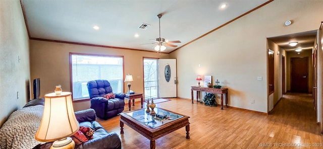 living area with crown molding, visible vents, light wood finished floors, and ceiling fan