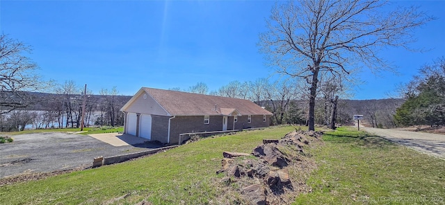view of property exterior with a yard and a garage