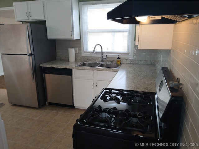 kitchen with custom range hood, light tile patterned floors, stainless steel appliances, a sink, and white cabinets
