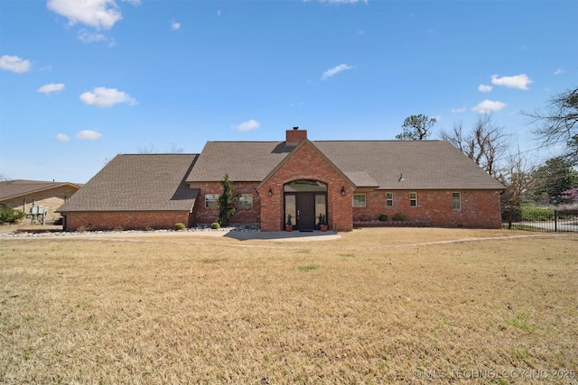 122 Osage Ridge Dr, Sand Springs, OK 74063 - view of front of home with brick siding, a chimney, a front yard, and roof with shingles