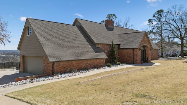 122 Osage Ridge Dr, Sand Springs, OK 74063 - view of side of property featuring a lawn, roof with shingles, concrete driveway, brick siding, and a chimney